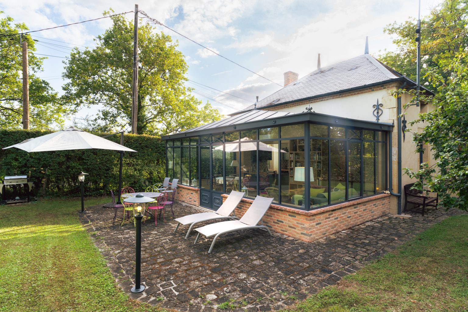 Terrasse et veranda du gite ouvertes sur le jardin de Sologne