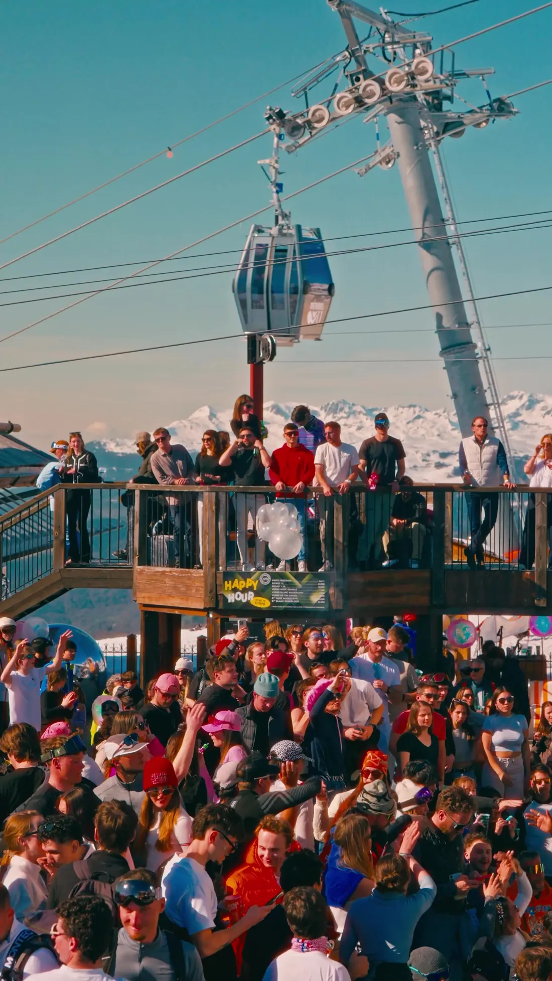 Cabine du Saulire Express et pylône au-dessus de la terrasse bondée de la Folie Douce, jour de closing à Méribel