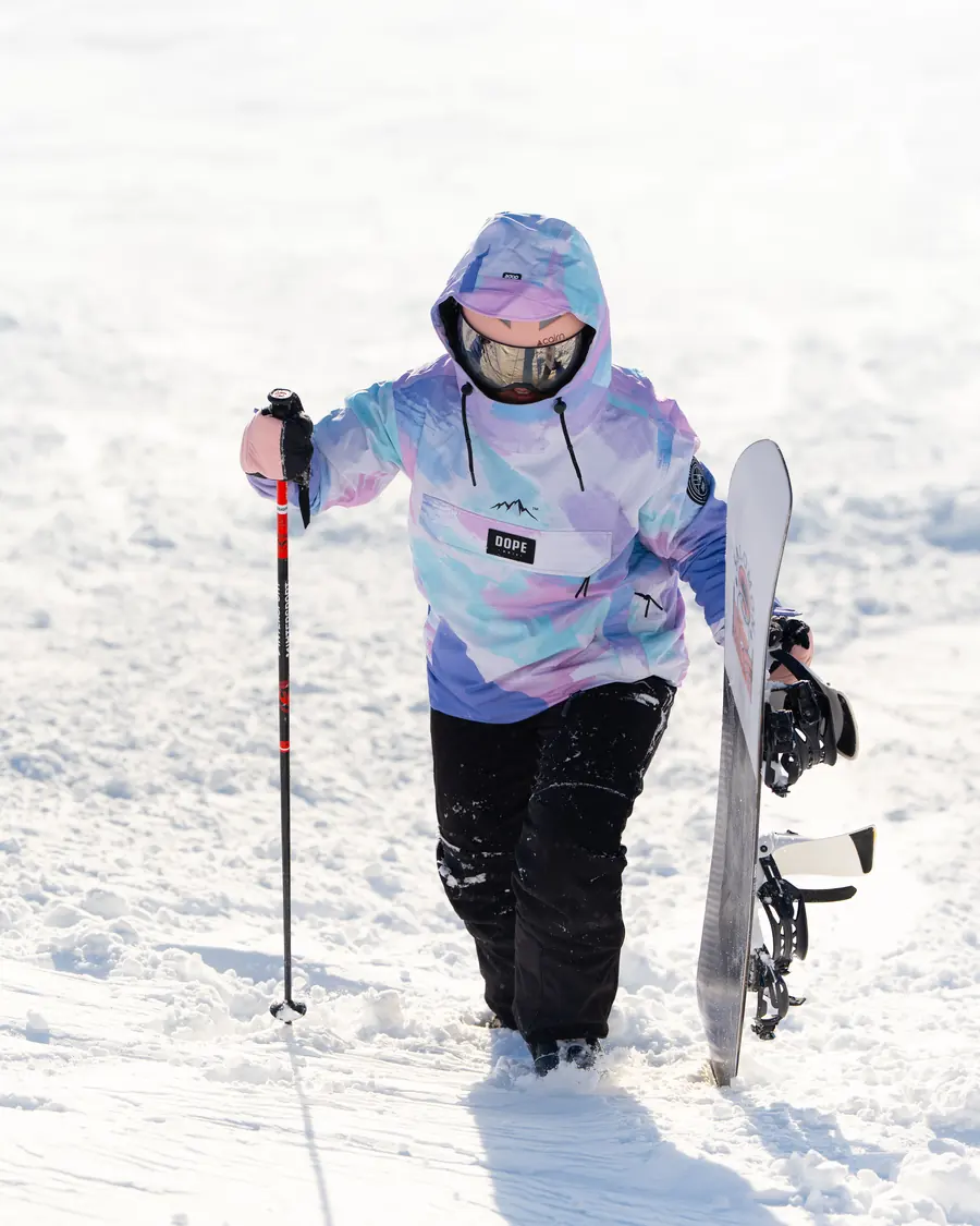 Skieuse en sweat pastel qui avance dans la neige profonde de Val Thorens